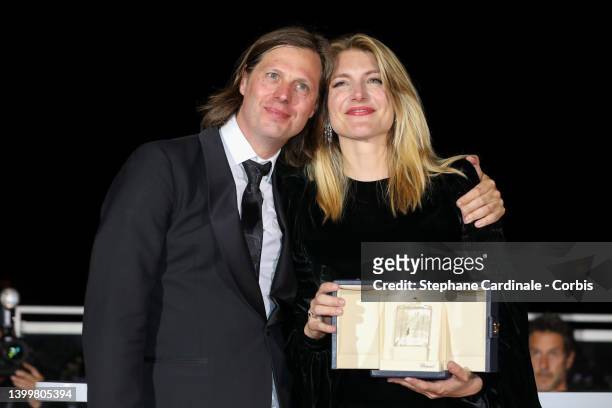 Directors Felix Van Groeningen and Charlotte Vandermeersch pose with the Jury Prize for the movie 'Le Otto Montagne' during the winner photocall...