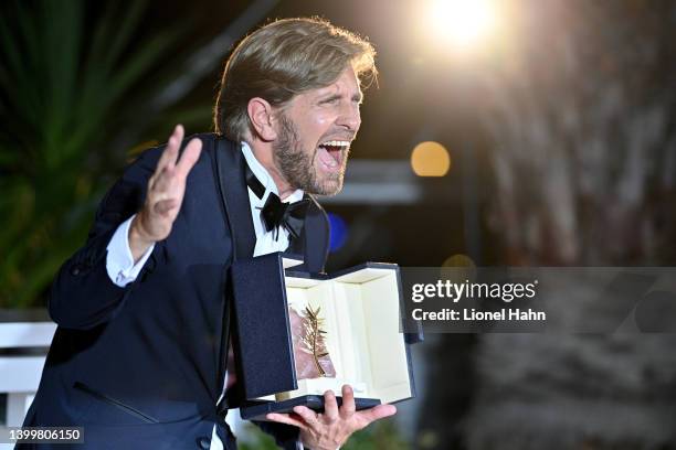 Director Ruben Ostlund poses with the Palme d'Or Award for "Triangle of Sadness" at the winner photocall during the 75th annual Cannes film festival...