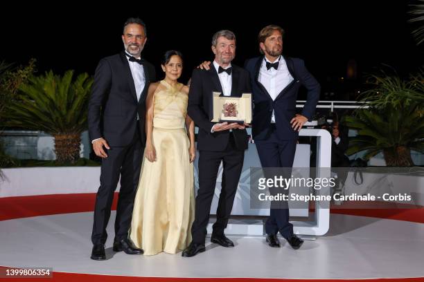 Erik Hemmendorff, Dolly De Leon, Philippe Bober and Director Ruben Ostlund pose with the Palme d'Or Award for "Triangle of Sadness" at the winner...
