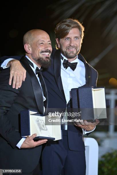 Ruben Ostlund poses with the Palme D'or Award for "Triangle of Sadness" and Tarik Saleh poses with the Best Screenplay Award for "Boy from Heaven" at...