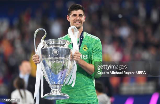 Thibaut Courtois of Real Madrid lifts the UEFA Champions League trophy after their sides victory during the UEFA Champions League final match between...