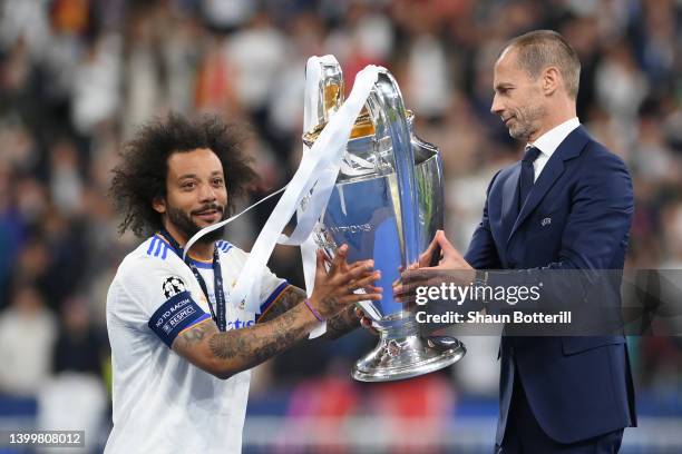 Marcelo of Real Madrid is handed the UEFA Champions League Trophy by Aleksander Ceferin, President of UEFA following their sides victory in the UEFA...