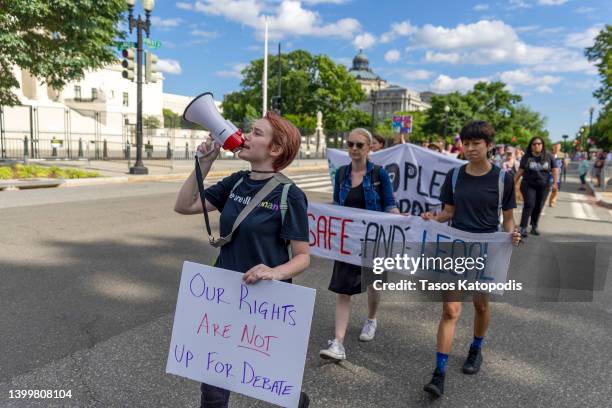 Protesters march near the Supreme Court to demand an end to gun violence and call for abortion rights protection on May 28, 2022 in Washington, DC....