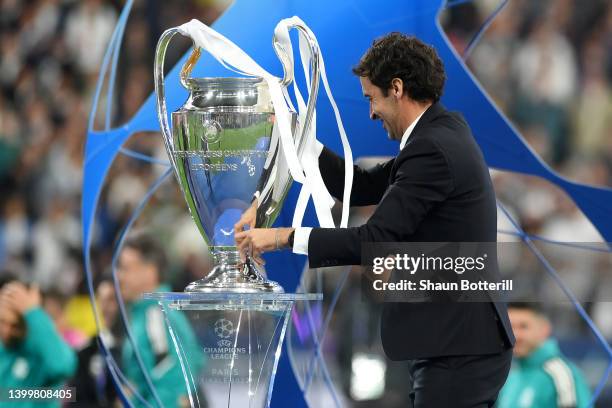 Former Real Madrid player Raul places the UEFA Champions League trophy on the podium prior to the trophy presentation after the final whistle of the...