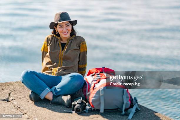 portrait of cheerful female traveller by sea - photographer seascape stock pictures, royalty-free photos & images