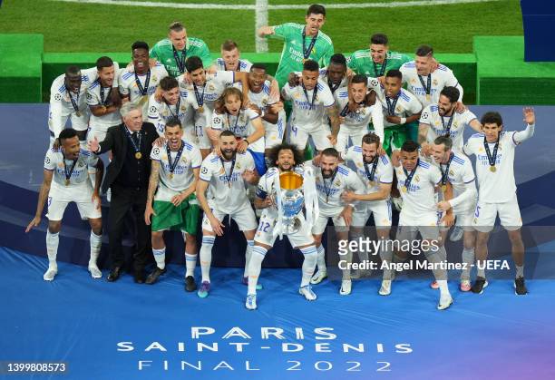 Players of Real Madrid celebrate as Marcelo of Real Madrid lifts the UEFA Champions League Trophy after their sides victory after the final whistle...