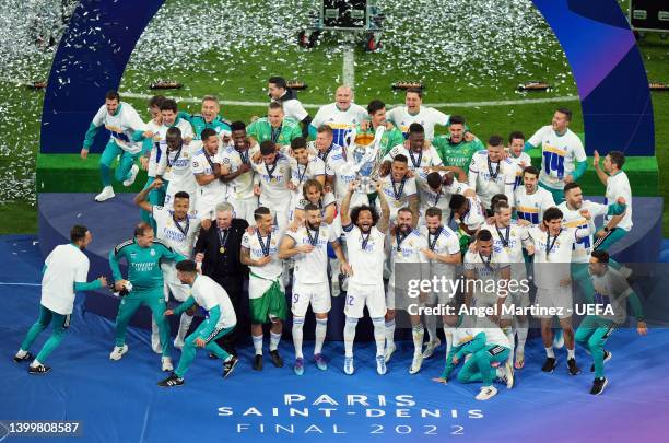 Staff and Players of Real Madrid celebrate as Marcelo of Real Madrid lifts the UEFA Champions League Trophy after their sides victory after the final...