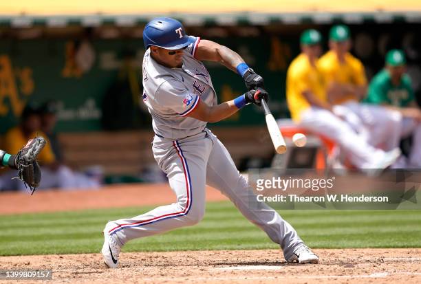 Andy Ibanez of the Texas Rangers hits an rbi single scoring Kole Calhoun against the Oakland Athletics in the top of the fifth inning at RingCentral...