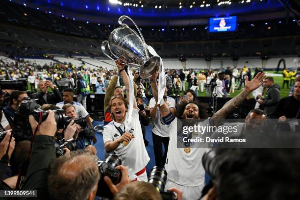 Luka Modric and Marcelo of Real Madrid celebrate with the UEFA Champions League trophy after their sides victory during the UEFA Champions League...