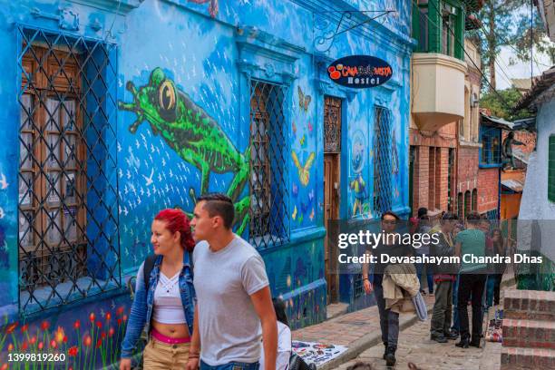 bogotá, colombia - tourists and local colombians on the narrow, cobblestoned calle del embudo in the historic la candelaria district of the andes capital city in south america - calle del embudo stock pictures, royalty-free photos & images