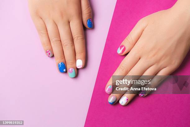 playful abstract art summer manicure in blue and purple colors. - hand white background stock pictures, royalty-free photos & images