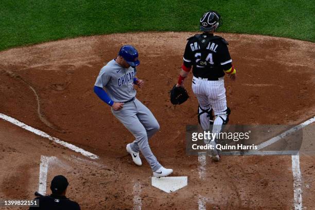 Nico Hoerner of the Chicago Cubs scores in the second inning past catcher Yasmani Grandal of the Chicago White Sox at Guaranteed Rate Field on May...