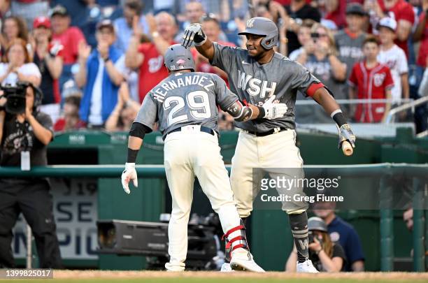 Yadiel Hernandez of the Washington Nationals celebrates with Maikel Franco after hitting a home run in the sixth inning against the Colorado Rockies...