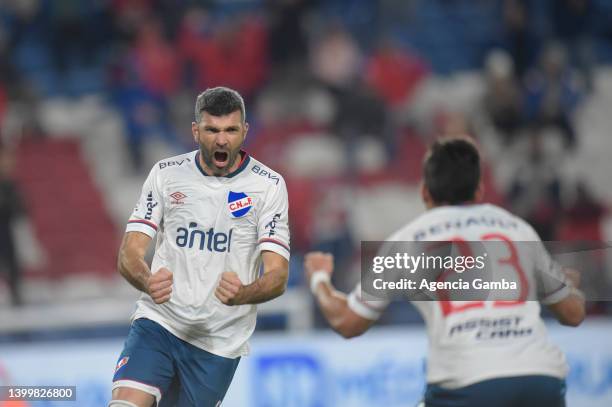 Emmanuel Gigliotti, of Nacional celebrates with his team mate Alex Castro, after scoring the first goal, during a match between Nacional and Cerrito...