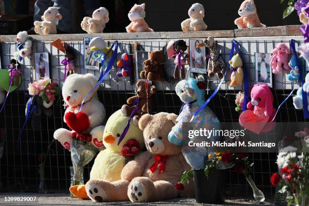 Flowers and teddy bears are seen in a memorial for the victims of the Robb Elementary School mass shooting during a vigil at Sacred Heart Catholic...