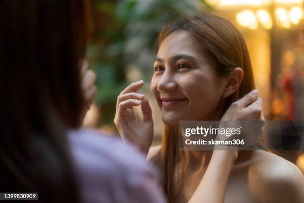 candid moment positive emotion couple asian females lesbian lgbt lovers dating and take care each other at public space. - asian lesbians kiss stock pictures, royalty-free photos & images