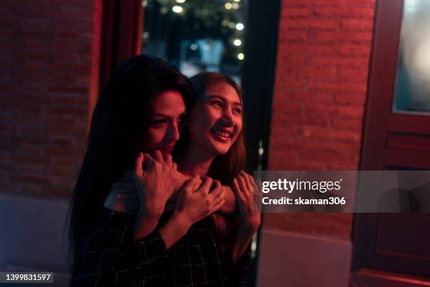 candid moment positive emotion couple asian females lesbian lgbt lovers embracing at public space - asian lesbians kiss stock pictures, royalty-free photos & images