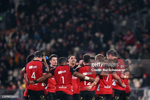 Pablo Matera of the Crusaders and his team mates huddle during the round 15 Super Rugby Pacific match between the Crusaders and the Queensland Reds...