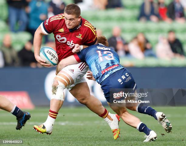 Ethan De Groot of the Highlanders is tackled by Andrew Kellaway of the Rebels during the round 15 Super Rugby Pacific match between the Melbourne...