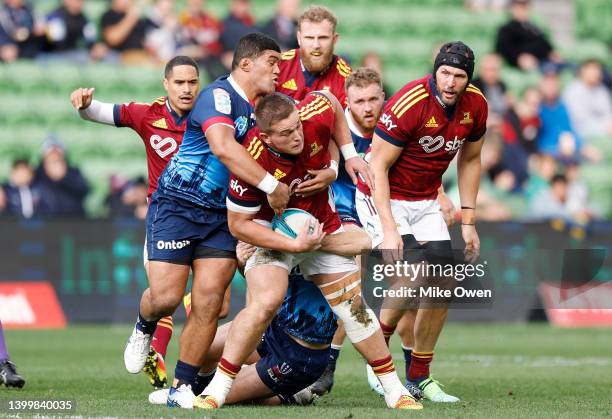 Ethan De Groot of the Highlanders is tackled during the round 15 Super Rugby Pacific match between the Melbourne Rebels and the Highlanders at AAMI...