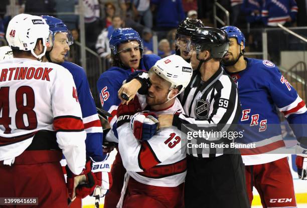 Braden Schneider of the New York Rangers and Max Domi of the Carolina Hurricanes tangle late in the third period in Game Six of the Second Round of...