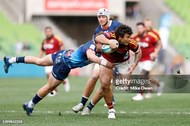 Thomas Umaga-Jensen of the Highlanders is tackled by Reece Hodge of the Rebels during the round 15 Super Rugby Pacific match between the Melbourne...