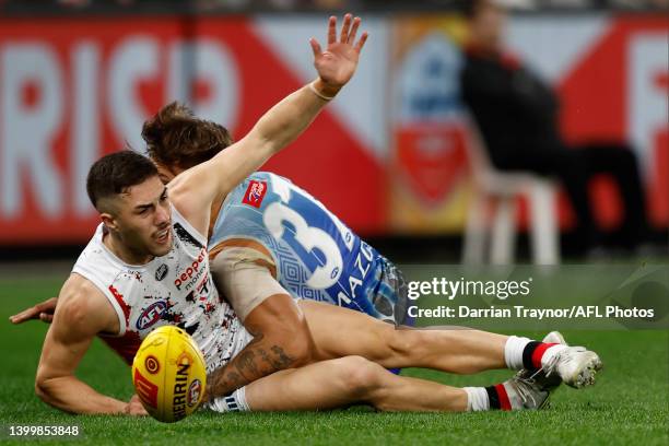 Jade Gresham of the Saints is tackled during the round 11 AFL match between the St Kilda Saints and the North Melbourne Kangaroos at Marvel Stadium...