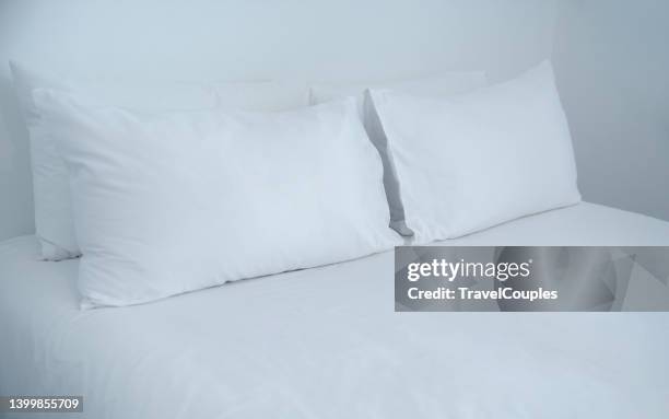 bedroom interior with a white bedding. white bed sheets and pillows - värdshus bildbanksfoton och bilder