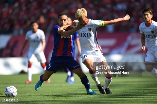 Yuma Suzuki of Kashima Antlers and Yuto Nagatomo of FC Tokyo compete for the ball during the J.LEAGUE Meiji Yasuda J1 16th Sec. Match between...