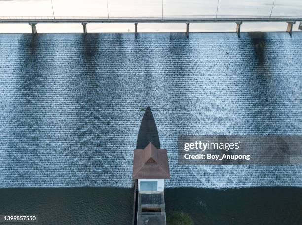 the control room in front of mae suai reservoir (or dammed valleys) in chiang rai province of thailand discharging water flows over the spillway into the river below. - hydroelectric power stock pictures, royalty-free photos & images