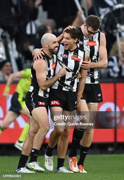 Patrick Lipinski of the Magpies is congratulated by team mates after kicking a goal during the round 11 AFL match between the Collingwood Magpies and...