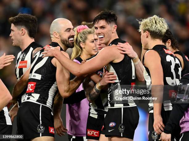Oliver Henry of the Magpies is congratulated by team mates after kicking a goal during the round 11 AFL match between the Collingwood Magpies and the...