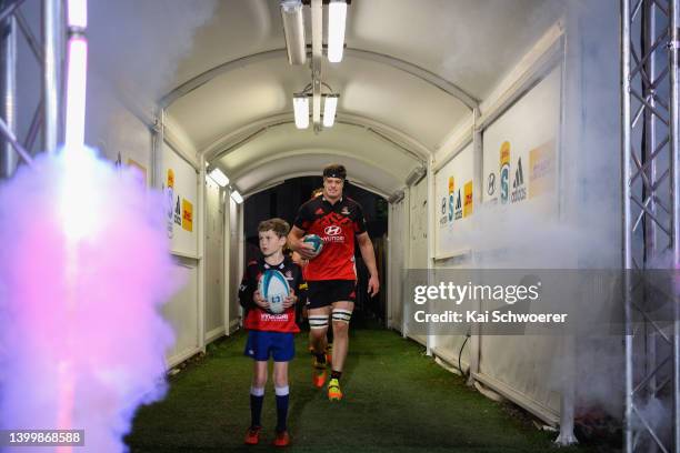 Captain Scott Barrett of the Crusaders leads his team onto the field prior to the round 15 Super Rugby Pacific match between the Crusaders and the...