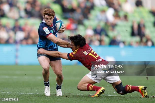 Andrew Kellaway of the Rebels breaks the tackle from Josh Timu of the Highlanders during the round 15 Super Rugby Pacific match between the Melbourne...