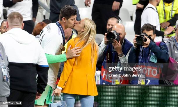 Goalkeeper of Real Madrid Thibaut Courtois kisses his girlfriend Mishel Gerzig during the celebration following the UEFA Champions League final match...