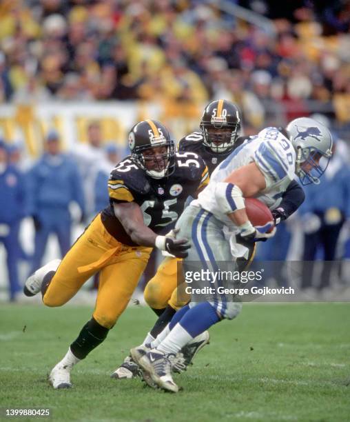 Linebacker Joey Porter of the Pittsburgh Steelers tackles fullback Cory Schlesinger of the Detroit Lions as linebacker Earl Holmes of the Steelers...