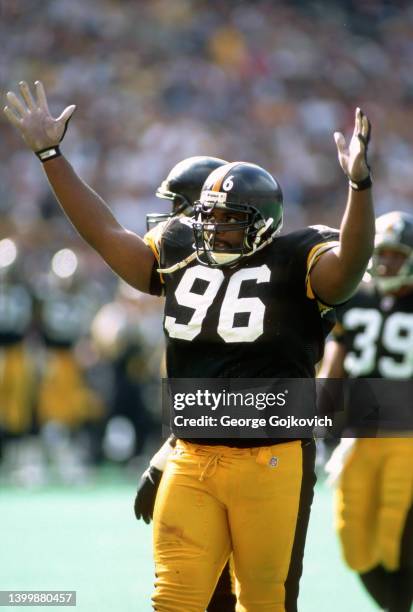 Defensive lineman Brentson Buckner of the Pittsburgh Steelers encourages the fans to cheer during a game against the Houston Oilers at Three Rivers...