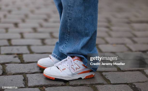 Sonia Lyson wearing Weekday denim wide pants, New Balance 550 white and orange sneaker on May 25, 2022 in Berlin, Germany.