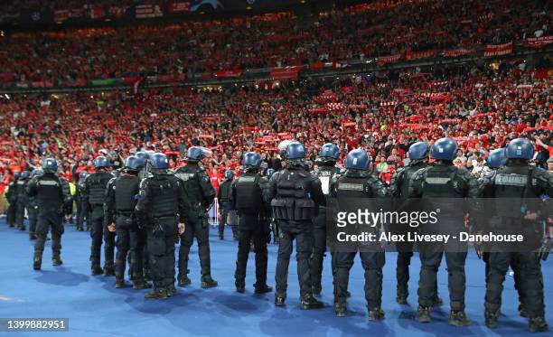 Riot police watch supporters of Liverpool FC during the UEFA Champions League final match between Liverpool FC and Real Madrid at Stade de France on...