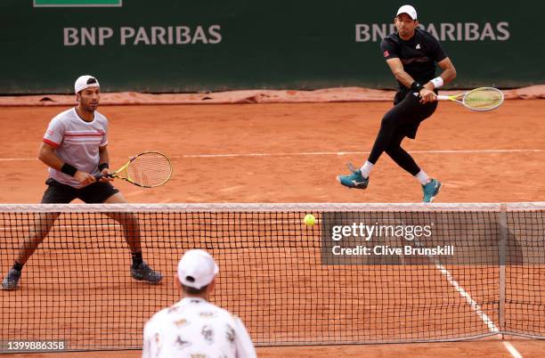 Marcelo Arevalo of El Salvador plays a forehand as partner Jean-Julien Rojer of Netherlands looks on against Tim Puetz of Germany and Michael Venus...