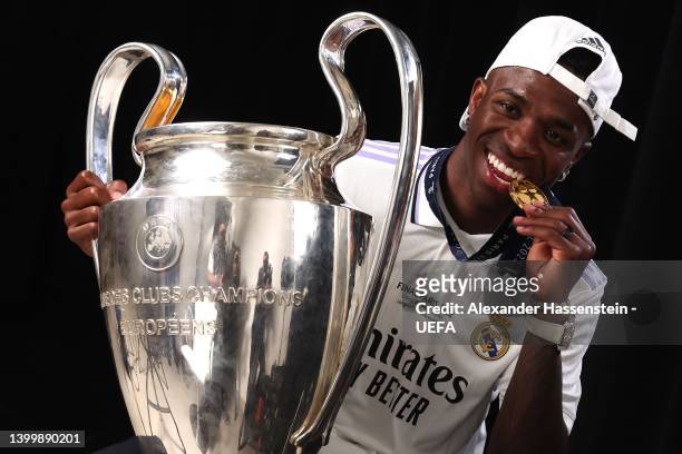 Vinicius Paixao de Oliveira Junior of Real poses with the UEFA Champions League trophycafter their sides victory during the UEFA Champions League...