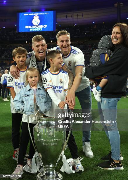 Toni Kroos of Real poses with the UEFA Champions League trophy his wife his Jessica Kroos and his brother Felix Kroos after their sides victory...