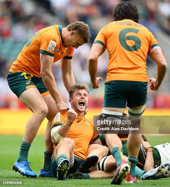 Nick Malouf of Australia celebrates with Ben Marr and Henry Paterson after victory in the Cup Quarter-Final match between Australia and South Africa...