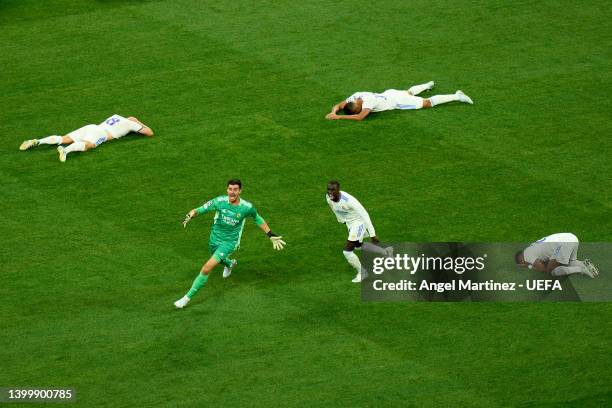 Players of Real Madrid led by Thibaut Courtois of Real Madrid celebrate after the final whistle is blown to confirm their side as winners of the UEFA...