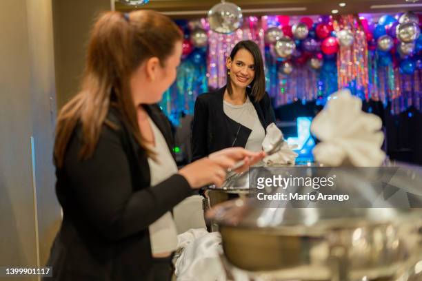 co-workers make the party buffet - event planner stock pictures, royalty-free photos & images