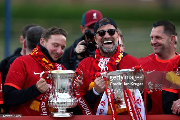 Pep Lijnders, Assistant Manager and Jurgen Klopp, Manager of Liverpool pose with the FA Cup and the Carabao Cup Trophy during the Liverpool Trophy...