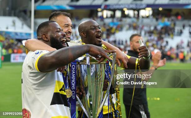 Dany Priso , Dillyn Leyds and and Raymond Rhule of La Rochelle, celebrate with the Champions Cup after their victory during the Heineken Champions...