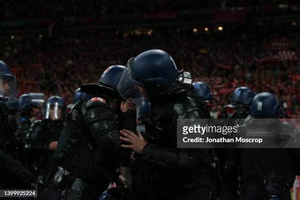 French Gendarmerie in anti-riot attire discuss as they line up in front of the Liverpool fans during the UEFA Champions League final match between...