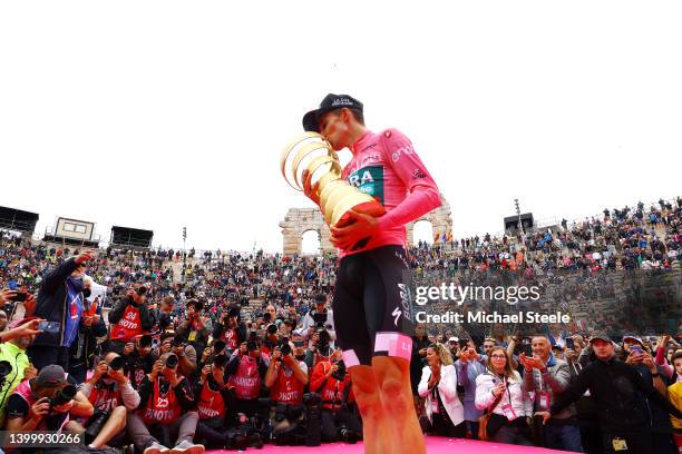 Jai Hindley of Australia and Team Bora - Hansgrohe Pink Leader Jersey celebrates at podium with the Trofeo Senza Fine as overall race winner during...