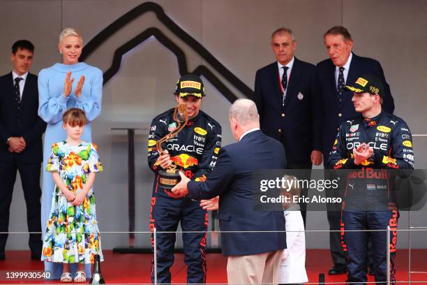 Race winner Sergio Perez of Mexico and Oracle Red Bull Racing is presented with his trophy by Prince Albert of Monaco during the F1 Grand Prix of...